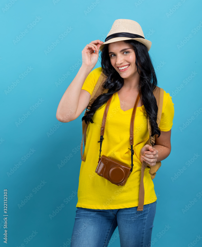 Happy young woman hiking on a blue background Happy young woman hiking on a blue background