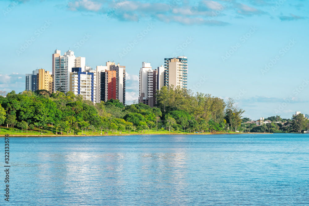 View of a lake of a green city with a lot of trees and few buildings. Photo of the Igapo lake, Londrina PR Brazil. View of a lake of a green city with a lot of trees and few buildings. Photo of the Igapo lake, Londrina PR Brazil.