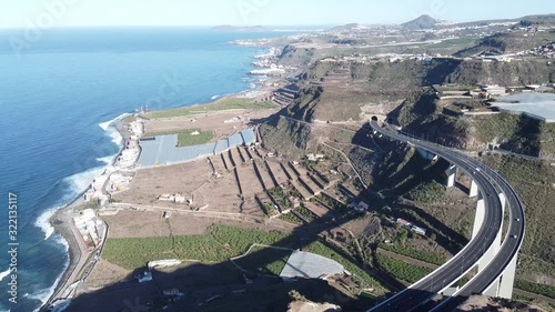 Landing view of Dron Video footage of Ocean coast line and high way with tunnel and briges filmed at Gran Canaria, Spain.  photo