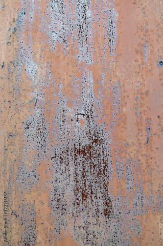 Old painted and rusted metal sheet with scratches as background. Texture of a rusty steel panel.