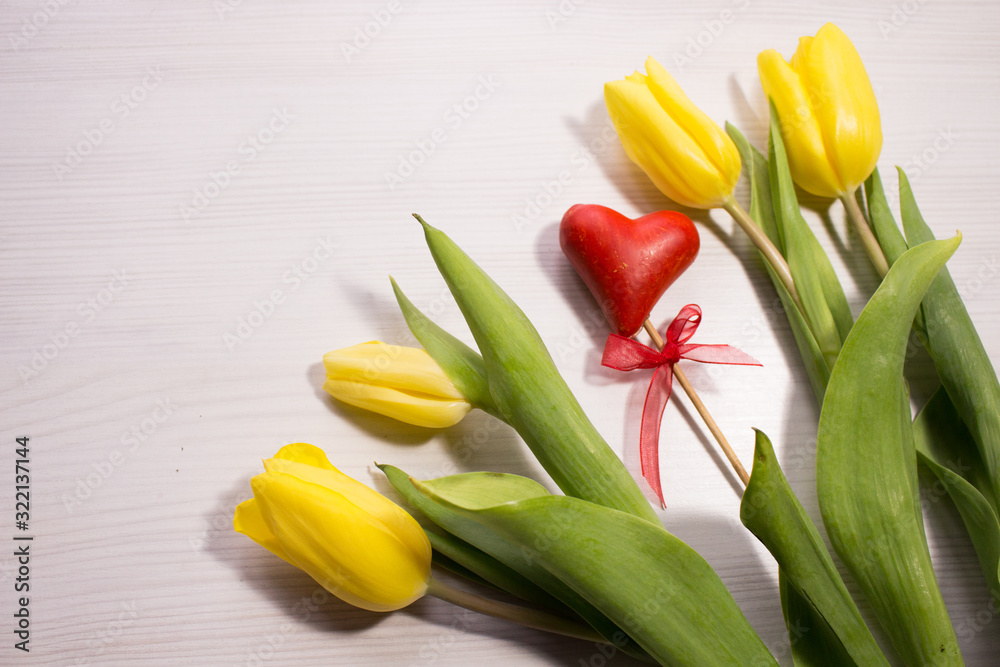 Flower tulip on white wooden background. Bouquet of the yellow tulip flowers. Valentines day concept, woman's day. Red gift box. Flower tulip on white wooden background. Bouquet of the yellow tulip flowers. Valentines day concept, woman's day. Red gift box.