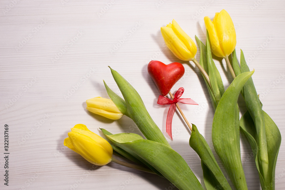 Flower tulip on white wooden background. Bouquet of the yellow tulip flowers. Valentines day concept, woman's day. Red gift box. Flower tulip on white wooden background. Bouquet of the yellow tulip flowers. Valentines day concept, woman's day. Red gift box.
