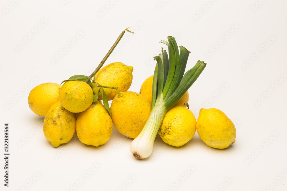 Yellow lemons and fresh green vegetables