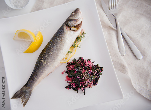 fish dinner with lemon, cooked chard and quinoa photo
