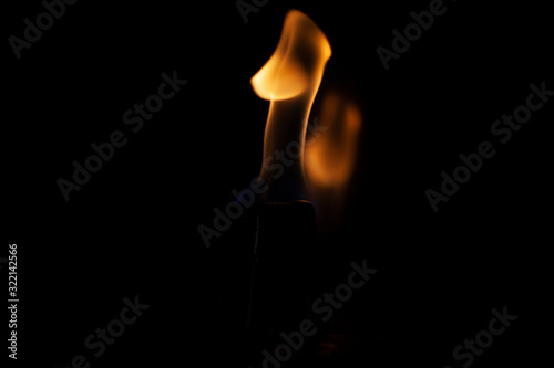 Flame texture on a dark background. The tongue of the flame is warm.