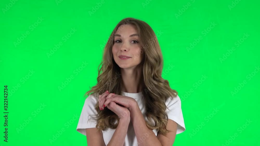 Lovable girl smiling while looking at camera. Green screen Lovable girl smiling while looking at camera. Green screen