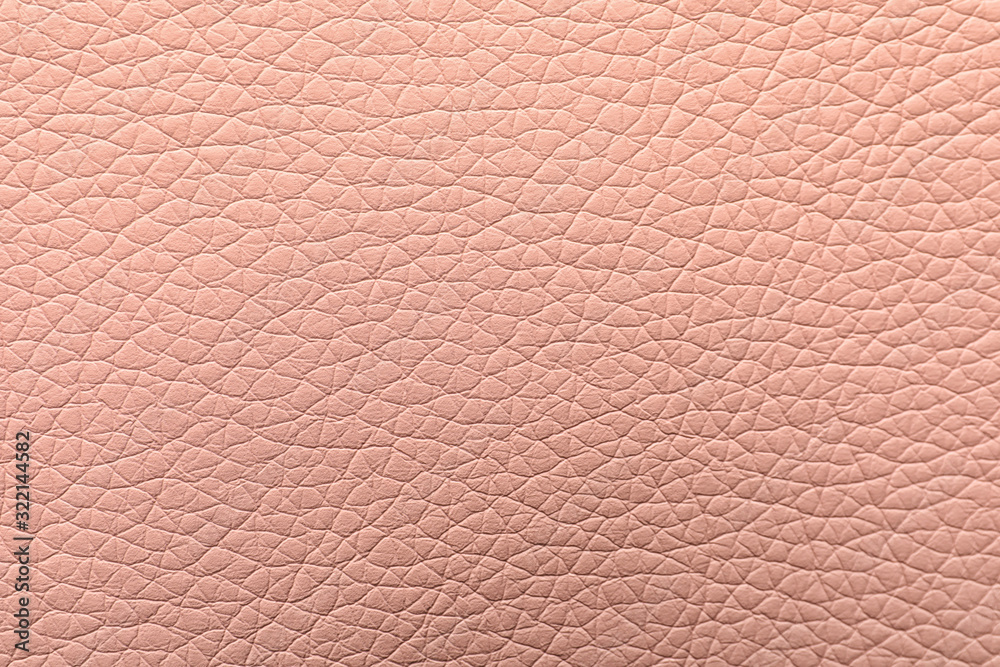Texture of light pink leather as background, closeup