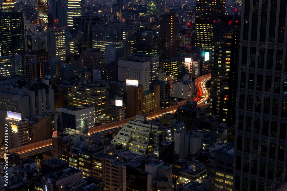 Large exposure in Tokyo night. Lights, cars and office buildings in illuminated Tokyo night. Japan, Asia