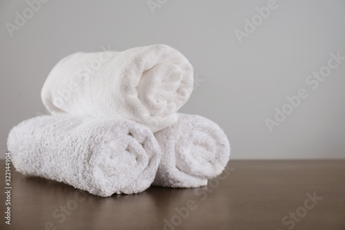 Clean rolled towels on dark grey table. Space for text