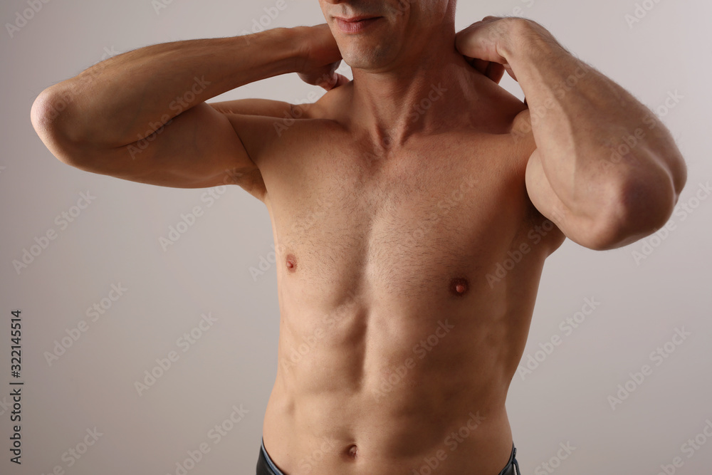 Muscular Man suffering from back and neck pain. Chiropractic concept. Sport exercising injury Muscular Man suffering from back and neck pain. Chiropractic concept. Sport exercising injury