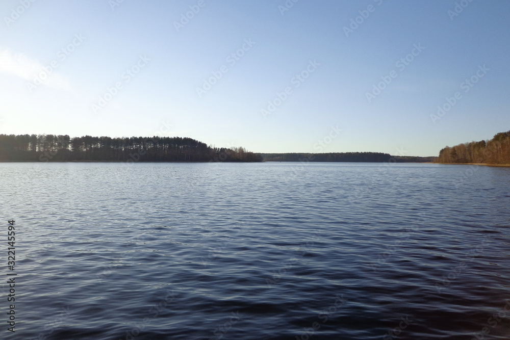 View of the lake in the sunny evening View of the lake in the sunny evening