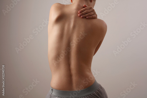 Woman with back pain, Scoliosis spine curve. Female body parts aesthetic, asymmetry photo