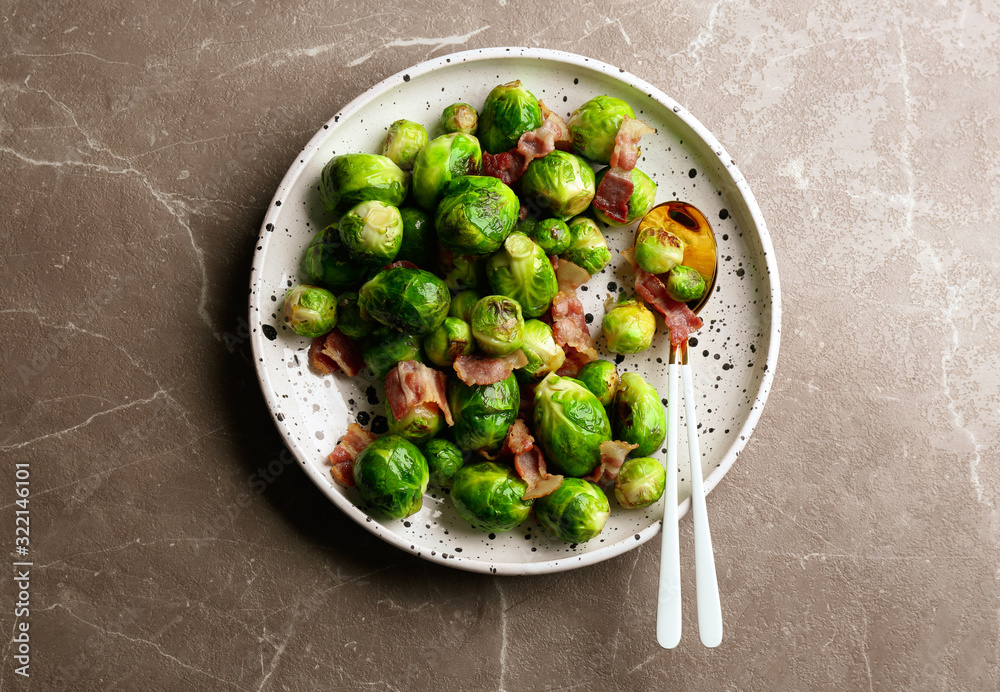 Delicious Brussels sprouts with bacon on marble table, top view Delicious Brussels sprouts with bacon on marble table, top view