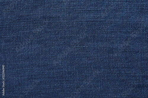 Texture of dark blue jeans as background, closeup