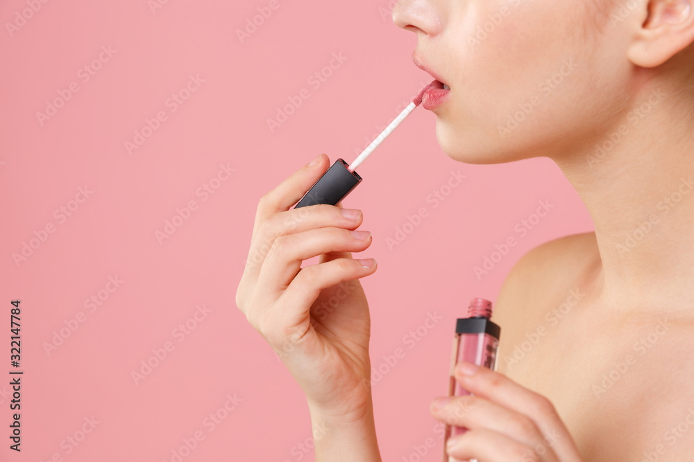 Close up cropped blonde half naked woman 20s perfect skin nude make up isolated on pastel pink wall background studio portrait. Skin care healthcare cosmetic procedures concept. Hold liquid lipstick. Close up cropped blonde half naked woman 20s perfect skin nude make up isolated on pastel pink wall background studio portrait. Skin care healthcare cosmetic procedures concept. Hold liquid lipstick.