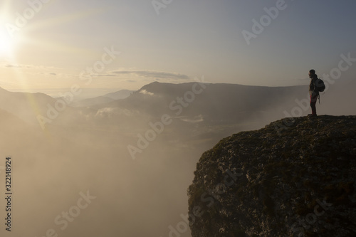 man on the edge of the cliff with the sun at dawn, Balcon de Pilatos, Sierra de Urbasa, Navarra photo