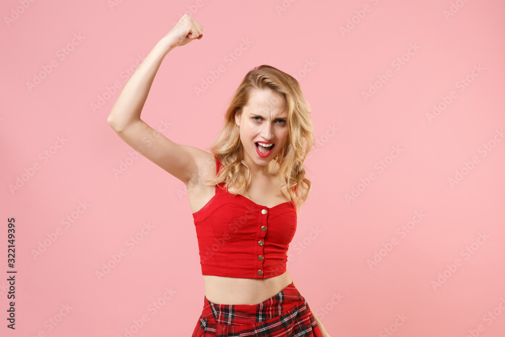 Young blonde woman girl in red sexy clothes posing isolated on pastel pink background in studio. People lifestyle concept. Mock up copy space. Doing winner gesture expressive gesticulating with hands. Young blonde woman girl in red sexy clothes posing isolated on pastel pink background in studio. People lifestyle concept. Mock up copy space. Doing winner gesture expressive gesticulating with hands.