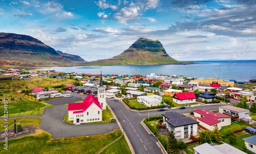 View from flying drone. Splendid morning cityscape of Grundarfjordur town with Kirkjufell Mountain on background. Aerial view of Grundarfjordur Church, Iceland, Europe. Traveling concept background. photo