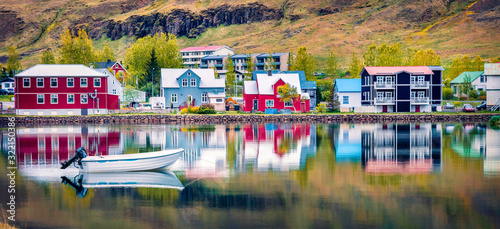 Panoramic morning cityscape of small fishing town - Seydisfjordur. Calm summer scene of east west Iceland, Europe. Traveling concept background.