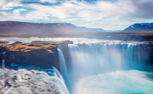 Bright summer view of Skjalfandafljot river, Iceland, Europe. Fantastic morning scene of Godafoss, spectacular waterfall plunging over a curved, 12m-high precipice, with paths to various viewpoints.