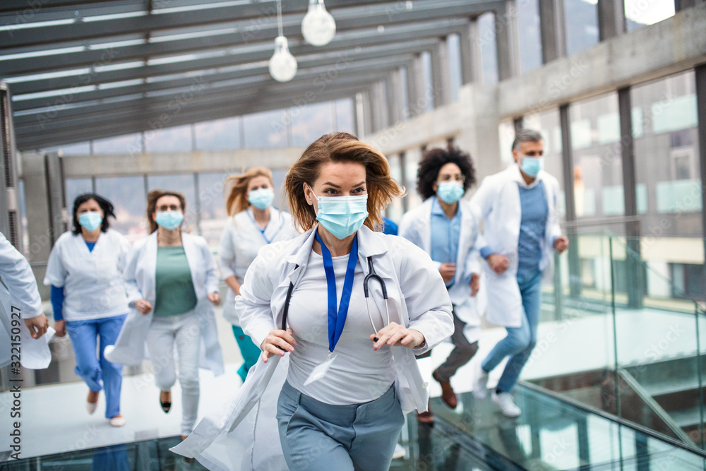 Group of doctors with face masks running, corona virus concept.