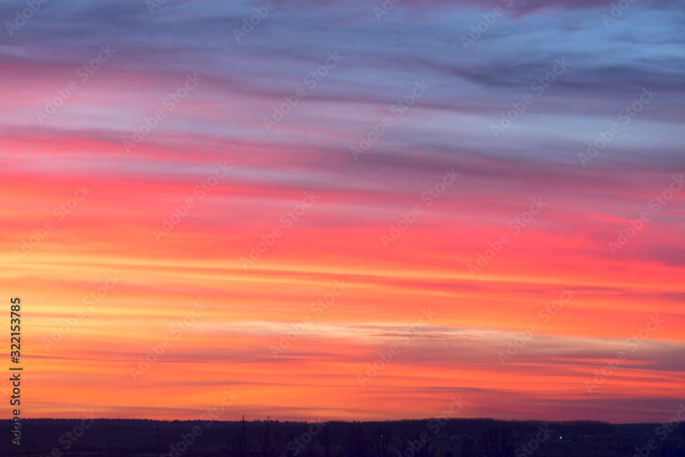 The bright fiery colors of sunset in the mountains are a beautiful sight. Red clouds can be used as background in digital processing.