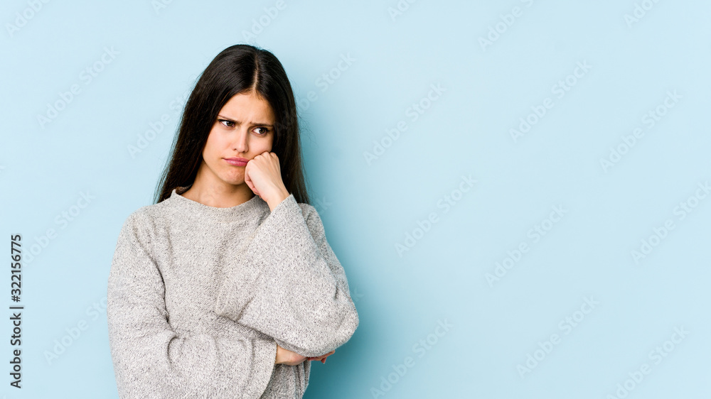Young caucasian woman isolated on blue background who feels sad and pensive, looking at copy space. Young caucasian woman isolated on blue background who feels sad and pensive, looking at copy space.