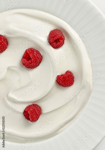 plate of greek yogurt with raspberries