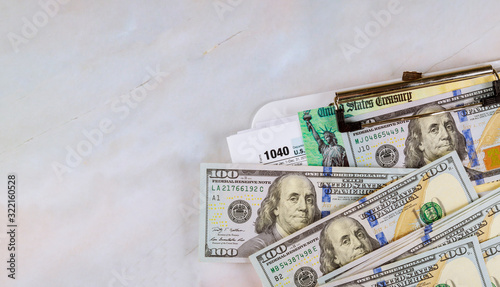 Принти на полотні IRS 1040 tax return form with currency US dollar banknotes close up