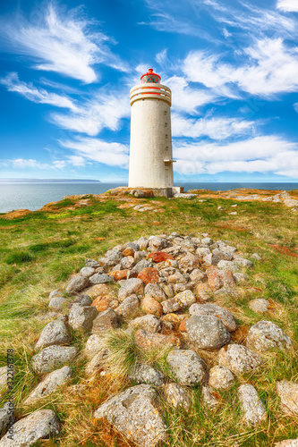 Stunning view of Skarsviti lighthouse in Vatnsnes peninsula on a clear day in North Iceland. photo