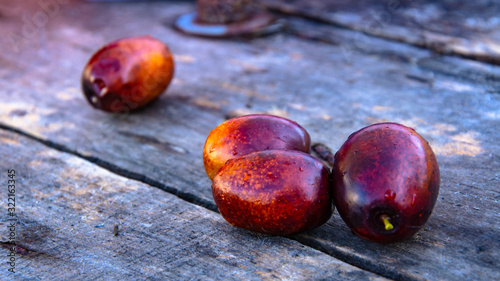 A handful of ripe jujube on old wooden boards.