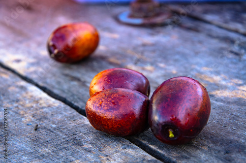 A handful of ripe jujube on old wooden boards.