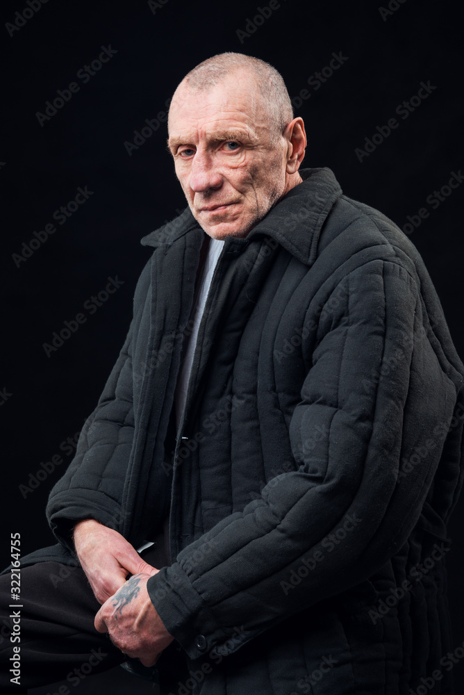 Portrait of a prisoner old man on a black background Portrait of a prisoner old man on a black background