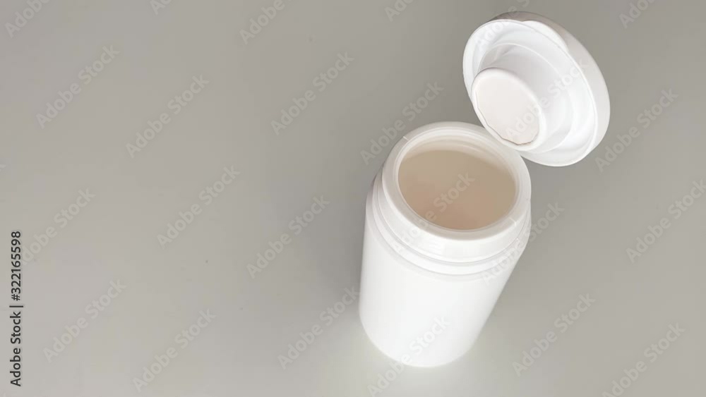 Medicine capsules falling into a boat on a white surface. Concept of medicine. Medicine capsules falling into a boat on a white surface. Concept of medicine.