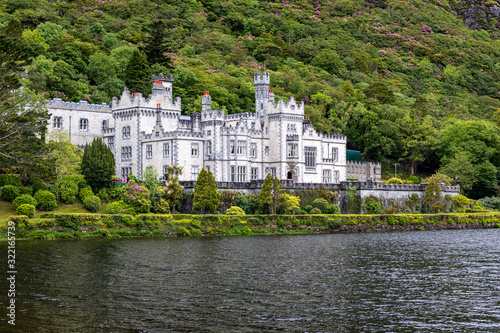 Kylemore abbey between Irish lake & forest  photo