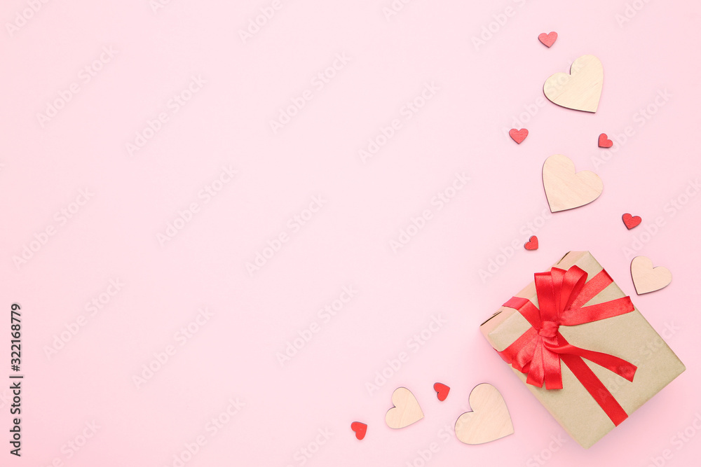 Gift box with ribbon and hearts on pink background