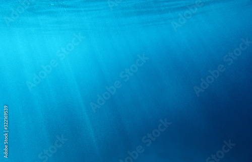 The texture of the underwater surface with the rays of the sun