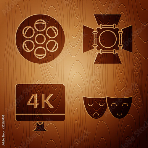 Set Comedy and tragedy theatrical masks , Film reel , Computer PC monitor with 4k video technology and Movie spotlight on wooden background. Vector