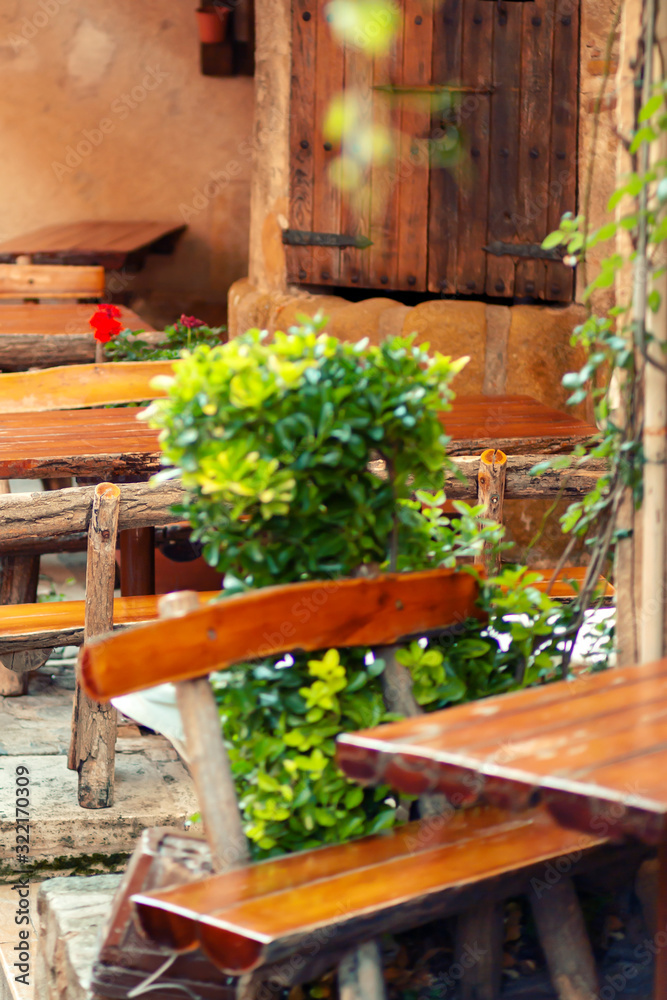 Wooden tables of vintage street cafes in the village style.
