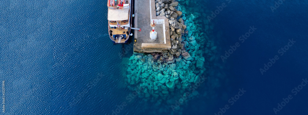 Aerial drone ultra wide photo of yacht docked in old port of Mykonos island, Cyclades, Greece