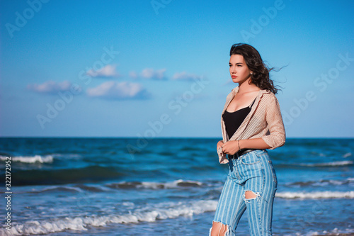 a girl stand at the beach