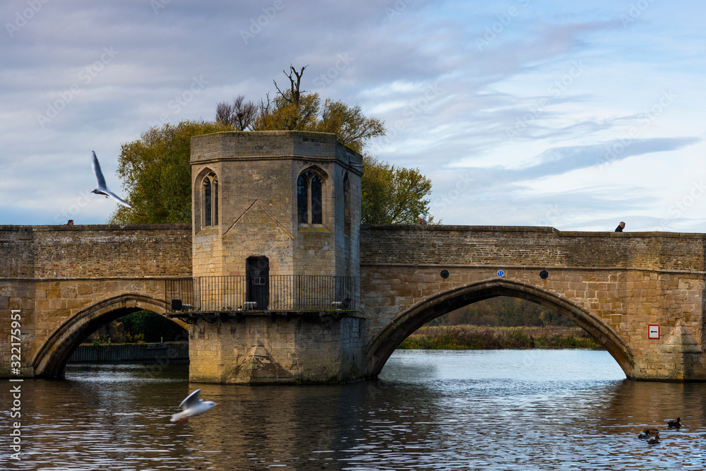 River Great Ouse with the medieval St Leger Chapel Bridge at St Ives, Cambridgeshire, England, UK. River Great Ouse with the medieval St Leger Chapel Bridge at St Ives, Cambridgeshire, England, UK.
