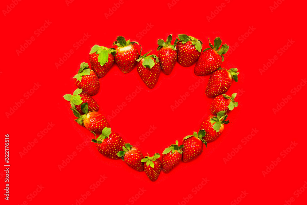 Frame of red strawberries in shape of heart