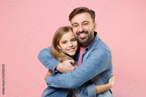 Smiling bearded man in casual clothes have fun with cute child baby girl. Father little kid daughter isolated on pastel pink background in studio. Love family parenthood childhood concept. Hugging.