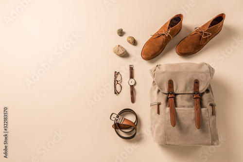 Men's accessories - camel shoes, khaki backpack and leather belt photo