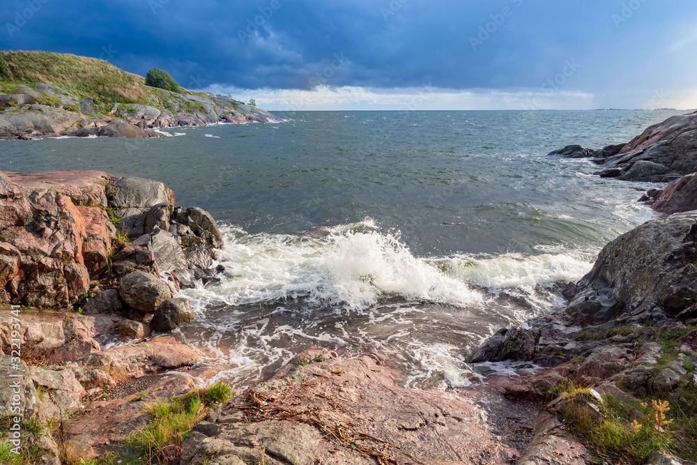 Finland. Landscape of the coast of Finland. View of the Gulf of Finland from the shore. Panorama of the bay. Waves splashing against stones on the shore. Nature of Helsinki. Travels. Finland. Landscape of the coast of Finland. View of the Gulf of Finland from the shore. Panorama of the bay. Waves splashing against stones on the shore. Nature of Helsinki. Travels.