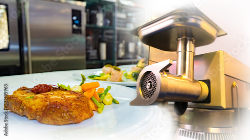 Meat grinder next to a stea...