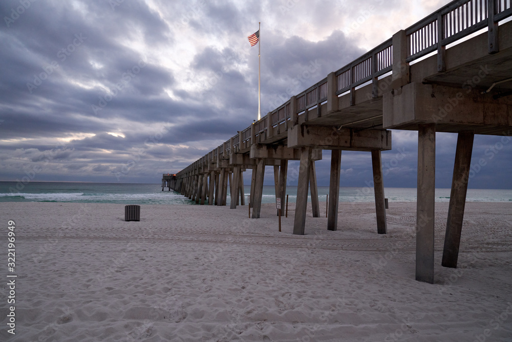 Scenic View of Pier in Panama Beach City with rolling clouds and sand