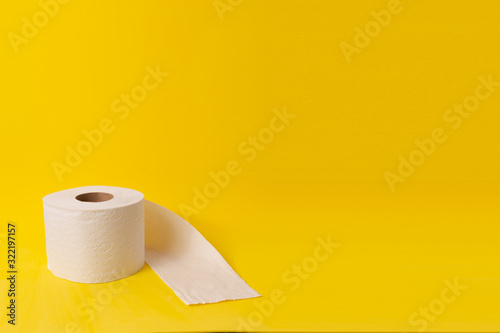 Topical care and love: toilet paper on yellow background. Cleaning and decontamination concept.