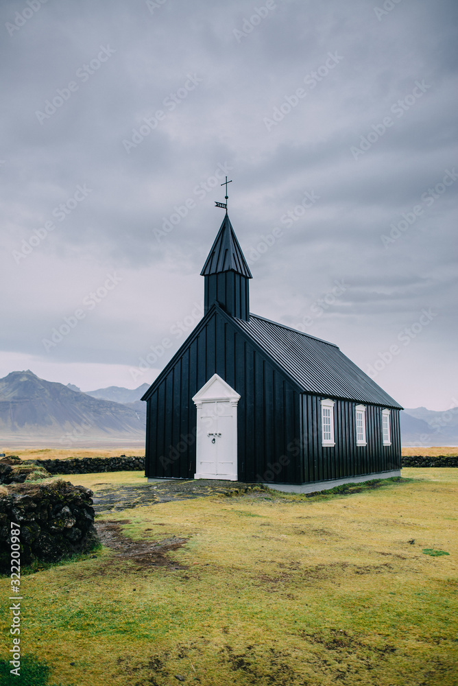 Icelandic landscape with a black church of Budir at Snaefellsnes peninsula region. Cloudy day.